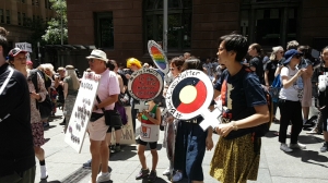 Person holds a sign in the shape of a 